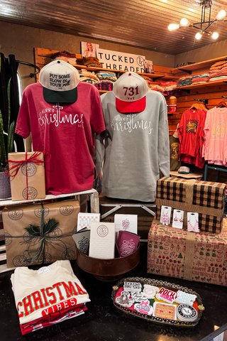 Image of Christmas shirts and hats from Tucked & Threaded | Greenfield, TN