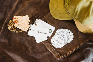 flatlay photo of product tags from tucked & threaded business