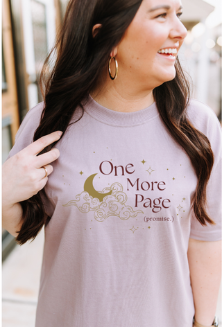 Woman wearing a t-shirt with 'One More Page' text and graphic