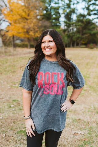 Woman wearing a 'Rock Soul' t-shirt in an outdoor setting with trees and grass.