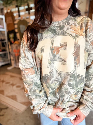 famle model with photo showing the area code 731 sweatshirt for ladies setting inside she-shed of tucked & threaded
