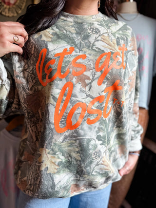 female model holding her hair back and showing her "let's get lost" camo graphic sweatshirts for southner camping mamas