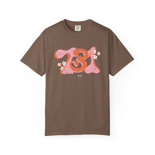 Brown t-shirt with pink and orange design on a white background
