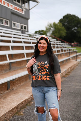 graphic tee for laides spriit tee that reads "paint the town orange"