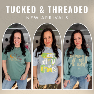 Three women wearing t-shirts with text designs, with 'Tucked & Threaded' branding.