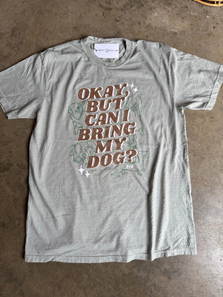 Gray t-shirt with graphic design and text on a concrete floor