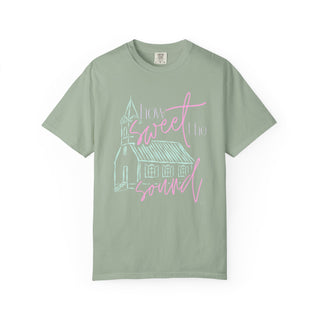 Green t-shirt with a church graphic and 'How sweet the sound' text on a white background