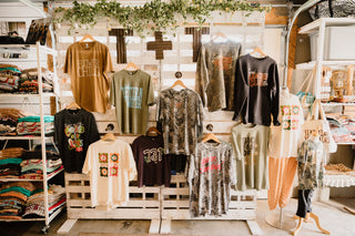 image of she-shed display pallet wall featuring graphic tees and sweatshirt for ladies